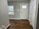 Bright foyer with hardwood floors, a glass-paneled front door, and a convenient coat closet at 7440 S 250 W, Pendleton, IN 46064