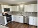 Modern kitchen featuring stainless steel appliances, white cabinetry and gray subway tile backsplash at 7440 S 250 W, Pendleton, IN 46064