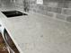 Close-up of kitchen island showcasing quartz countertops and stainless steel sink at 7440 S 250 W, Pendleton, IN 46064
