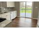 Bright kitchen showcases stainless steel appliances, white cabinetry, and access to the backyard at 7440 S 250 W, Pendleton, IN 46064