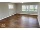 Open living room with hardwood floors and large windows offering a scenic view of the yard at 7440 S 250 W, Pendleton, IN 46064