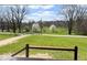 Scenic view from the porch showcasing a lush green lawn and mature trees across the street at 7440 S 250 W, Pendleton, IN 46064