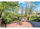 Back deck featuring a table and seating, overlooking a large, fenced-in yard at 7728 Mallard Way, Indianapolis, IN 46256