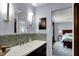 Modern bathroom vanity with a white countertop, mosaic backsplash, and stylish lighting at 7728 Mallard Way, Indianapolis, IN 46256
