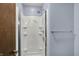 White fiberglass shower with shelves and modern fixtures at 7728 Mallard Way, Indianapolis, IN 46256