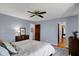 Bedroom featuring hardwood floors, a ceiling fan, and large window for natural light at 7728 Mallard Way, Indianapolis, IN 46256