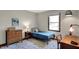 Bedroom featuring a bed, wood dresser, and a geometrically patterned rug at 7728 Mallard Way, Indianapolis, IN 46256