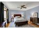 Comfortable bedroom featuring hardwood floors, natural light and ceiling fan at 7728 Mallard Way, Indianapolis, IN 46256