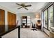 Bedroom featuring a ceiling fan, natural light, desk, and shelving at 7728 Mallard Way, Indianapolis, IN 46256