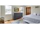 Bedroom featuring a bed, wood dresser, and multiple windows at 7728 Mallard Way, Indianapolis, IN 46256