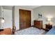 Bedroom featuring a bed, wood dresser, and closet with sliding doors at 7728 Mallard Way, Indianapolis, IN 46256