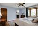 Bedroom featuring hardwood floors, a ceiling fan, and large window for natural light at 7728 Mallard Way, Indianapolis, IN 46256