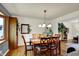Bright dining room featuring hardwood floors, stylish furnishings, and an adjacent living space at 7728 Mallard Way, Indianapolis, IN 46256