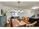 A beautiful dining room features hardwood floors, modern lighting, and flows into the kitchen area at 7728 Mallard Way, Indianapolis, IN 46256