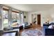 Cozy living room with large windows, hardwood floors, comfortable seating, and stylish area rug at 7728 Mallard Way, Indianapolis, IN 46256