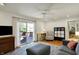 Bright living room with hardwood floors, ceiling fan and sliding door to outdoor deck at 7728 Mallard Way, Indianapolis, IN 46256