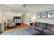 Bright living room featuring hardwood floors, ceiling fan, grey sofa and ottoman at 7728 Mallard Way, Indianapolis, IN 46256