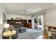 Cozy living room features a brick fireplace, ceiling fan, and access to a deck at 7728 Mallard Way, Indianapolis, IN 46256