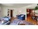 Open-concept living room with hardwood floors, neutral paint, comfortable seating, and stylish area rug at 7728 Mallard Way, Indianapolis, IN 46256