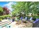Beautiful backyard featuring a stone patio with outdoor seating and lush landscaping at 8089 Lynch Ln, Indianapolis, IN 46250