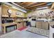 Organized basement workshop with pegboard walls, workbenches, and overhead lighting at 8089 Lynch Ln, Indianapolis, IN 46250