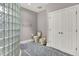 Neutral bathroom featuring a glass block shower wall and gray tiled floor at 8089 Lynch Ln, Indianapolis, IN 46250