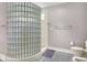 Clean bathroom featuring a glass block shower wall and gray tiled floor at 8089 Lynch Ln, Indianapolis, IN 46250