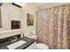 Cozy bathroom featuring a granite countertop, decorative shower curtain, and neutral wall decor at 8089 Lynch Ln, Indianapolis, IN 46250
