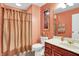 Well-lit bathroom featuring a vanity, toilet, and shower with a curtain, providing a functional and tidy space at 8089 Lynch Ln, Indianapolis, IN 46250