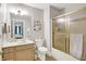 Bathroom with a beige vanity, toilet, and shower with gold trim at 8089 Lynch Ln, Indianapolis, IN 46250