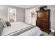 A bedroom featuring a large armoire and view into the en suite bath and upstairs hallway at 8089 Lynch Ln, Indianapolis, IN 46250