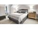 Bedroom with gray accents and a bed with side tables and lamps at 8089 Lynch Ln, Indianapolis, IN 46250