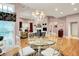 Bright dining area with hardwood floors and modern chandelier provides open access to a comfortable living room at 8089 Lynch Ln, Indianapolis, IN 46250