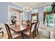 Elegant dining room with a chandelier, large table with six chairs, and decorative window treatments at 8089 Lynch Ln, Indianapolis, IN 46250