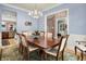 Traditional dining room with a large table and six chairs, with view into office and kitchen at 8089 Lynch Ln, Indianapolis, IN 46250