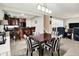 Dining area with dark wood table and striped chairs, near a wet bar and a living room at 8089 Lynch Ln, Indianapolis, IN 46250