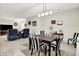 Dining area with a dark wood table, striped chairs, and a view into the living room at 8089 Lynch Ln, Indianapolis, IN 46250