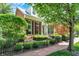 Beautiful brick home with manicured front lawn, black fence, brick walkway, and mature landscaping at 8089 Lynch Ln, Indianapolis, IN 46250