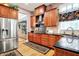 Well-lit kitchen with stainless steel fridge, range hood, hardwood floors and beautiful patterned dark rug at 8089 Lynch Ln, Indianapolis, IN 46250