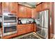 Well-equipped kitchen with stainless steel appliances, dark countertops, and cherry wood cabinets at 8089 Lynch Ln, Indianapolis, IN 46250