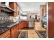 Open kitchen with stainless steel appliances, dark countertops, hardwood floors and access to the living room at 8089 Lynch Ln, Indianapolis, IN 46250