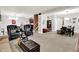 Large living room with a tan sofa, two dark armchairs, and a dining table at 8089 Lynch Ln, Indianapolis, IN 46250