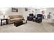 Spacious living room featuring a tan sofa and dark armchairs at 8089 Lynch Ln, Indianapolis, IN 46250