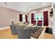 Elegant living room featuring hardwood floors, fireplace, and red curtain accents at 8089 Lynch Ln, Indianapolis, IN 46250