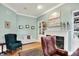Cozy home office featuring a fireplace, built-in shelving, hardwood floors, and traditional decor at 8089 Lynch Ln, Indianapolis, IN 46250