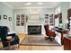 Bright home office with hardwood floors, a fireplace, built-in shelving, and traditional décor at 8089 Lynch Ln, Indianapolis, IN 46250