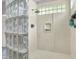 Modern shower featuring glass blocks, a shower head, and a built-in soap dish at 8089 Lynch Ln, Indianapolis, IN 46250
