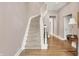 Elegant staircase featuring a curved design, carpeted steps, and natural light, enhancing the home's charm and accessibility at 8089 Lynch Ln, Indianapolis, IN 46250