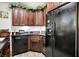 Wet bar with black appliances and dark cabinetry features granite countertop and sink at 8089 Lynch Ln, Indianapolis, IN 46250