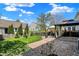 Manicured backyard with rock garden, patio with gazebo, and lush green lawn at 8116 Barksdale Way, Indianapolis, IN 46216